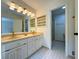 Well-lit bathroom with a double vanity, sleek fixtures, and a glass-enclosed shower at 3340 Zingara Rd, Conyers, GA 30012