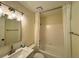 This bathroom has a tub and shower combination with white tile and marble sink at 3340 Zingara Rd, Conyers, GA 30012