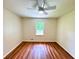 Bedroom with hardwood floors and a window overlooking the backyard at 3340 Zingara Rd, Conyers, GA 30012