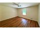 Bedroom featuring hardwood floors, neutral walls, and a window providing natural light at 3340 Zingara Rd, Conyers, GA 30012