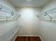 This walk-in closet has white wire shelving and hardwood floors at 3340 Zingara Rd, Conyers, GA 30012