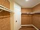 Walk-in closet with wood-style walls, white trim, and built-in shelving at 3340 Zingara Rd, Conyers, GA 30012