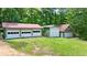 Exterior view of multi-car garage with overhead doors and adjacent green space at 3340 Zingara Rd, Conyers, GA 30012