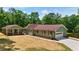 Ranch-style home features an attached garage, a large yard, and a lovely setting surrounded by lush greenery at 3340 Zingara Rd, Conyers, GA 30012