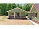 Charming cottage-style home with a brick foundation, a covered porch, and a beautifully landscaped walkway at 3340 Zingara Rd, Conyers, GA 30012