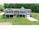Elevated exterior of home with green siding, brick accents, and an attached garage overlooking the yard at 3340 Zingara Rd, Conyers, GA 30012