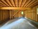 Exposed framing of a garage space with a staircase and concrete flooring at 3340 Zingara Rd, Conyers, GA 30012