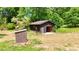 Exterior view of the backyard shed with a driveway approach at 3340 Zingara Rd, Conyers, GA 30012