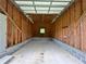 Empty one-car garage interior with concrete foundation and wood stud framing at 3340 Zingara Rd, Conyers, GA 30012