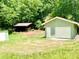 Detached garage offering ample space for parking and storage, nestled among the trees at 3340 Zingara Rd, Conyers, GA 30012
