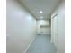 Hallway with patterned floors, neutral walls, and white trim at 3340 Zingara Rd, Conyers, GA 30012