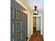 Hallway with stylish light fixture and hardwood flooring, leading to other rooms in the home at 3340 Zingara Rd, Conyers, GA 30012