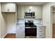This kitchen features stainless steel appliances, gray cabinets, and granite countertops at 3340 Zingara Rd, Conyers, GA 30012