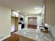 Bright kitchen features granite counters, white cabinets, and modern appliances at 3340 Zingara Rd, Conyers, GA 30012
