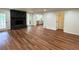 Open-concept living area with hardwood floors, stone fireplace, and seamless flow to the modern kitchen at 3340 Zingara Rd, Conyers, GA 30012