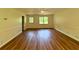 Living room featuring hardwood floors, white wainscoting, windows, and ceiling fan at 3340 Zingara Rd, Conyers, GA 30012