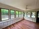 Cozy sunroom with hardwood floors, multiple windows offering a view of the trees, and lots of natural light at 3340 Zingara Rd, Conyers, GA 30012