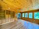 Spacious sunroom features wood paneling, hardwood floors, and built-in shelving at 3340 Zingara Rd, Conyers, GA 30012