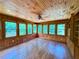 Sunroom boasts wood paneling, hardwood floors, and built-in shelving at 3340 Zingara Rd, Conyers, GA 30012