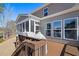 Open back deck features views of the screened porch and lake at 496 Spring View Dr, Woodstock, GA 30188