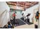 Basement gym with exercise equipment, including weights, elliptical machine, and stationary bike at 496 Spring View Dr, Woodstock, GA 30188