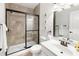 Modern bathroom featuring a glass-enclosed shower, a vanity with a sink, and neutral tiling at 496 Spring View Dr, Woodstock, GA 30188
