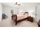 Bright bedroom featuring a ceiling fan, window with outdoor view, and a cozy chair at 496 Spring View Dr, Woodstock, GA 30188