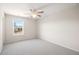Simple bedroom with plush neutral carpet, large window offering natural light and outdoor views at 496 Spring View Dr, Woodstock, GA 30188