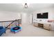 Spacious upstairs bonus room with TV, play area, and comfortable seating at 496 Spring View Dr, Woodstock, GA 30188