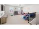 Spacious and bright upstairs bonus room features a play area and TV at 496 Spring View Dr, Woodstock, GA 30188