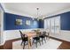 Elegant dining room with hardwood floors, wainscoting, and modern lighting fixtures at 496 Spring View Dr, Woodstock, GA 30188