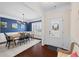 Elegant dining room with hardwood floors, wainscoting, and a view of the front entry at 496 Spring View Dr, Woodstock, GA 30188