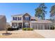 Charming two-story home with a stone facade, three-car garage, and well-manicured lawn at 496 Spring View Dr, Woodstock, GA 30188