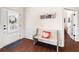 Welcoming foyer with hardwood floors and a cozy bench seat next to the front door at 496 Spring View Dr, Woodstock, GA 30188