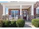 Inviting front porch with rocking chairs and stone accents for a cozy welcome at 496 Spring View Dr, Woodstock, GA 30188