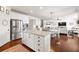 Open kitchen with stainless appliances, an eat-in island and seamless flow to a living area at 496 Spring View Dr, Woodstock, GA 30188