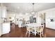 Open kitchen with granite countertops, stainless appliances and an eat-in breakfast nook with unique lighting at 496 Spring View Dr, Woodstock, GA 30188