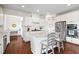 Modern kitchen features an island with granite countertops, stainless appliances, and white cabinets at 496 Spring View Dr, Woodstock, GA 30188