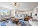 Spacious living room with a seamless flow to the kitchen, lots of light, and an eye-catching area rug at 496 Spring View Dr, Woodstock, GA 30188