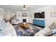 Inviting living room with a fireplace, comfortable seating, a TV, and an eye-catching area rug at 496 Spring View Dr, Woodstock, GA 30188