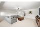 Spacious basement living room with sectional sofa, TV, and neutral-colored carpet at 496 Spring View Dr, Woodstock, GA 30188