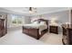 Main bedroom features a large window and wood furniture at 496 Spring View Dr, Woodstock, GA 30188