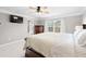Cozy main bedroom features a large window and mounted TV at 496 Spring View Dr, Woodstock, GA 30188