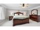 Spacious main bedroom features a ceiling fan, large windows, and wood furniture at 496 Spring View Dr, Woodstock, GA 30188
