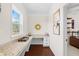 Home office with granite countertops, built-in cabinets, natural light from a large window, and hardwood floors at 496 Spring View Dr, Woodstock, GA 30188