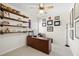 Office features built-in shelves, ceiling fan, large desk, and lots of natural light from a window at 496 Spring View Dr, Woodstock, GA 30188