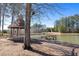 A gazebo near a pond with a dock, surrounded by trees and grass at 496 Spring View Dr, Woodstock, GA 30188