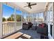 Comfortable screened porch featuring wicker furniture and a beautiful outdoor view at 496 Spring View Dr, Woodstock, GA 30188
