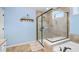 Main bathroom featuring a large glass shower, tiled walls, and natural light at 496 Spring View Dr, Woodstock, GA 30188
