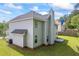 View of the backyard featuring a well maintained lawn and the rear of the home with neutral siding at 6895 Smoke Ridge Dr, Atlanta, GA 30349